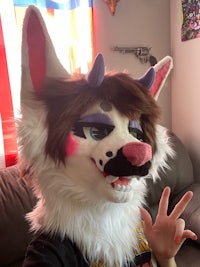 a person wearing a fox mask on a couch