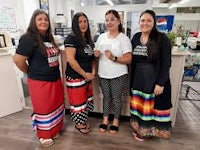 a group of women standing in front of a store