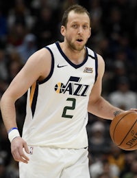 the utah jazz player is holding a basketball