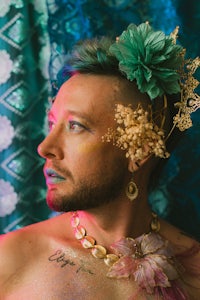 a man with flowers on his head