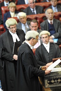 a group of people sitting in a courtroom