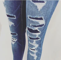 a pair of ripped jeans with holes on the knees