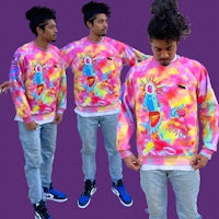 a man wearing a tie dye sweatshirt and a pair of jeans