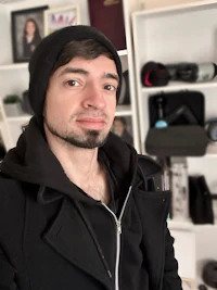 a man wearing a black jacket and beanie