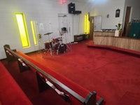 a church with red carpet and a drum set