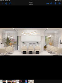 a photo of a salon with chairs and tables