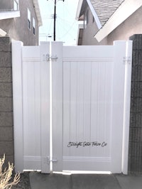 a white gate in a residential neighborhood