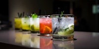 a group of drinks lined up on a table