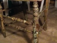 an old wooden stool in a room