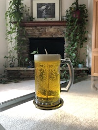 a glass of beer on a table in front of a fireplace