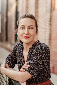 a woman leaning against a railing