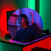 a man is sitting in front of a circular light