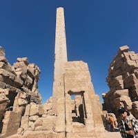a man standing in front of an obelisk in egypt
