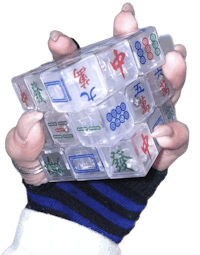 a person holding a plastic cube with chinese characters on it