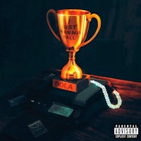 a gold trophy on a table next to a phone
