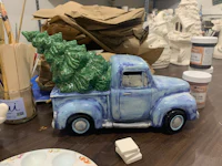 a blue truck with a christmas tree on it