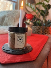 a candle is sitting on a table next to a candle