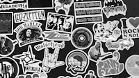 a black and white photo of various stickers on a wall