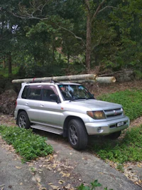 a toyota land cruiser parked in a wooded area