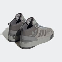 a pair of grey sneakers on a white surface