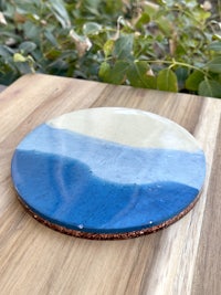 a blue and white ceramic plate on a wooden table