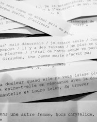 a black and white photo of several pieces of paper with words written on them