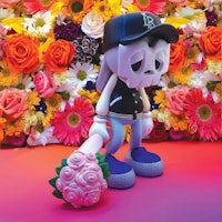a skeleton figure is standing in front of flowers