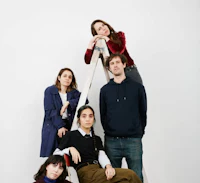 a group of people posing on a ladder