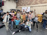 a group of people posing for a photo in a studio