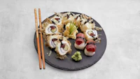 japanese sushi on a plate with chopsticks