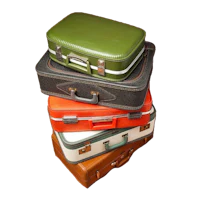 four suitcases stacked on top of each other