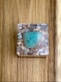 a small box with a turquoise stone in it