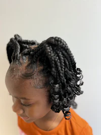 a little girl with braids in her hair