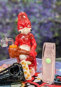 a glass figurine of a gnome sitting on a table