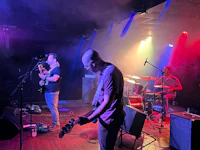 a group of people playing music on stage