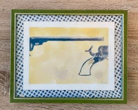 a framed print of a revolver and a pistol