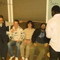 a group of men sitting on a couch