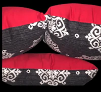 two black and red pillows on a black background