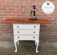 a white dresser with a telephone on top