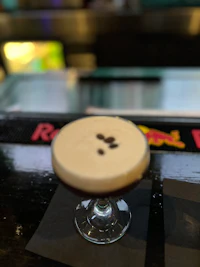 an irish coffee cocktail on a bar top