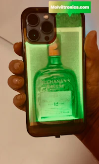 a person holding up a phone with a bottle of whiskey on it