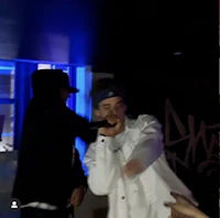 a man is holding a microphone in front of a crowd