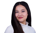 a woman with long hair posing for a photo