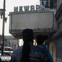 a man with dreadlocks and a child walking down a street