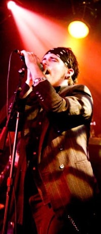 a man in a suit singing into a microphone