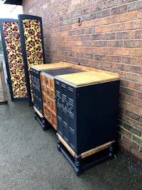 a black and white sideboard with a door on it