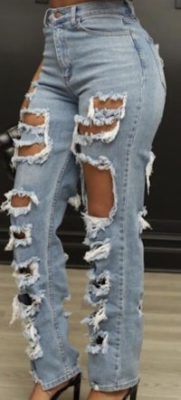 a woman wearing ripped jeans and heels