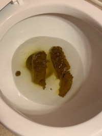a toilet with two pieces of meat in it