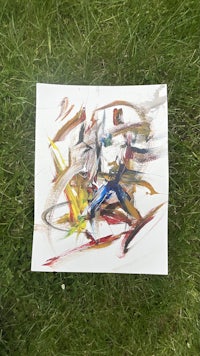 a painting of a man riding a bike in the grass