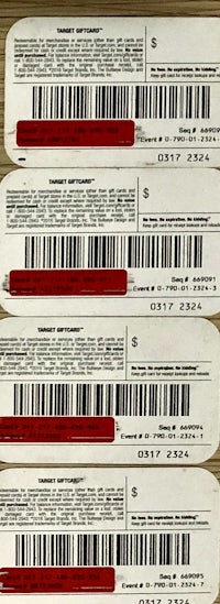 four red and white bar codes on a wooden table